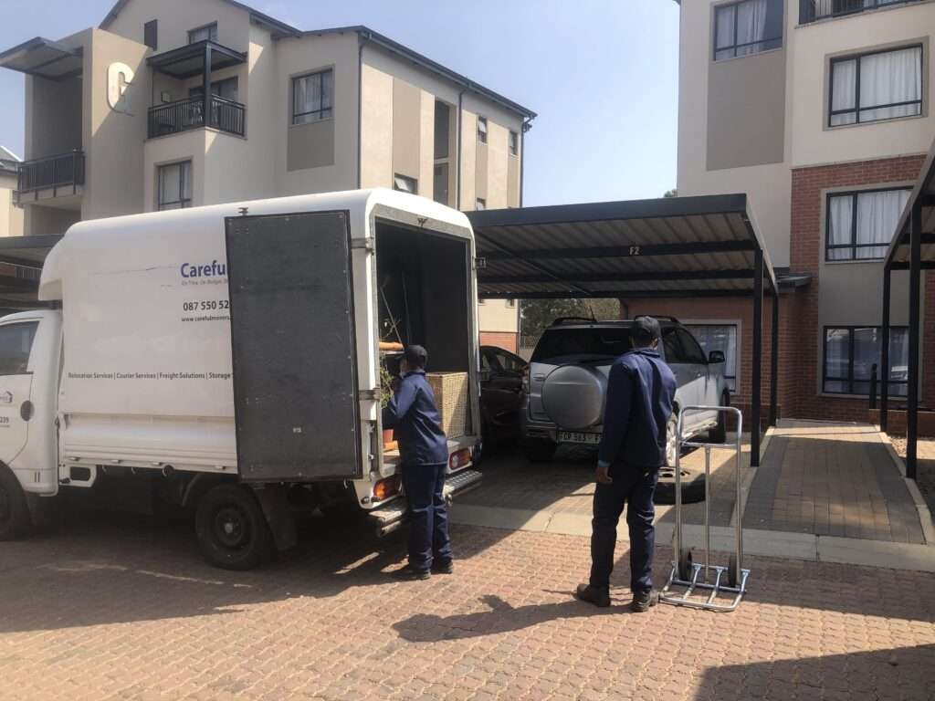Small load movers loading furniture items into a Careful Movers truck in Gauteng