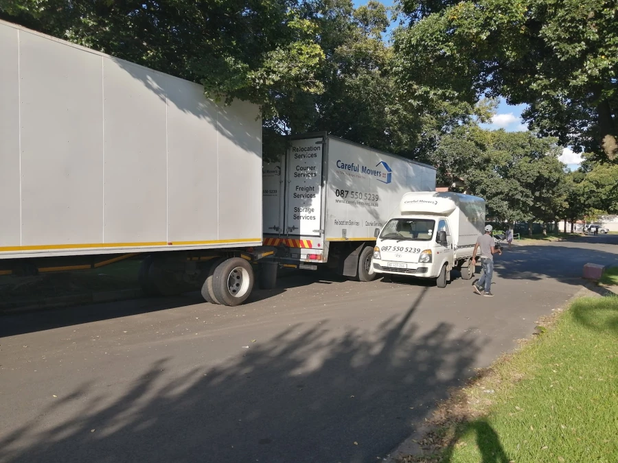 Careful Movers furniture removal truck and crew member on a suburban street