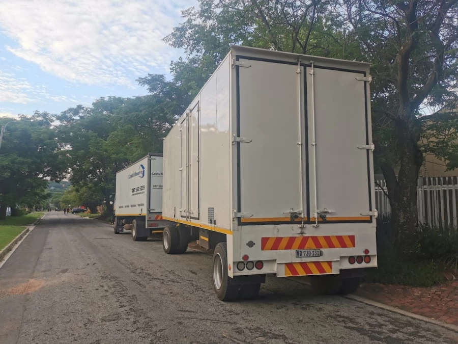Two Careful Movers furniture removal trucks parked on a suburban street