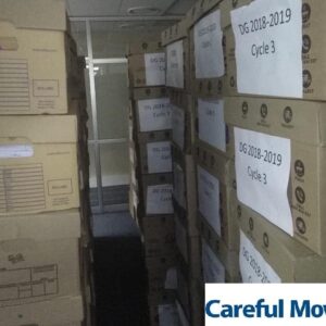 Labelled archive document boxes stacked in secure storage for a business client
